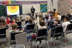 Kevin Pittner teaches second- and third-grade students about the lifecycle of trees.
