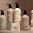 The 100% ocean-bound plastic bottle in earth-tone colors with a black dispensing pump is being used for five Landscape Collection hotel products from LATHER.