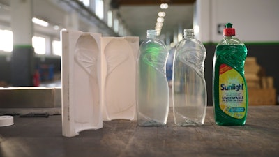 Bottles produced with a 3D printed tool are nearly indistinguishable from the final product produced through traditional metal tooling processes. From left to right: the two-part mold 3D printed with Rigid 10K Resin, a bottle produced with the mold 3D printed with Rigid 10K Resin, a bottle produced with a metal mold, and a labeled prototype bottle for customer testing.
