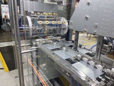 Delivered to Club Coffee as flat blanks like the ones shown here, the canister components are pulled from magazine feeds and formed into a finished container.