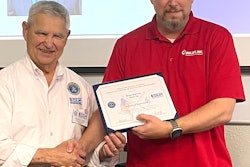 InkJet's Dean Harvey (left) receives the award from George Nami, Ombudsman Director with the ESGR.