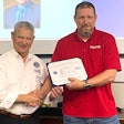 InkJet's Dean Harvey (left) receives the award from George Nami, Ombudsman Director with the ESGR.