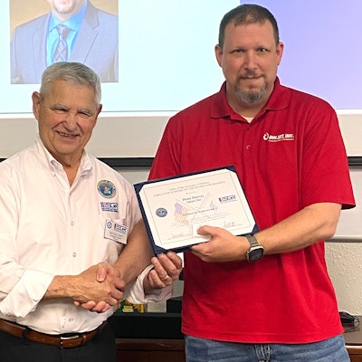 InkJet's Dean Harvey (left) receives the award from George Nami, Ombudsman Director with the ESGR.