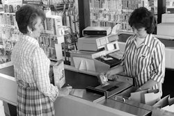 A customer checks out in the 1970s.