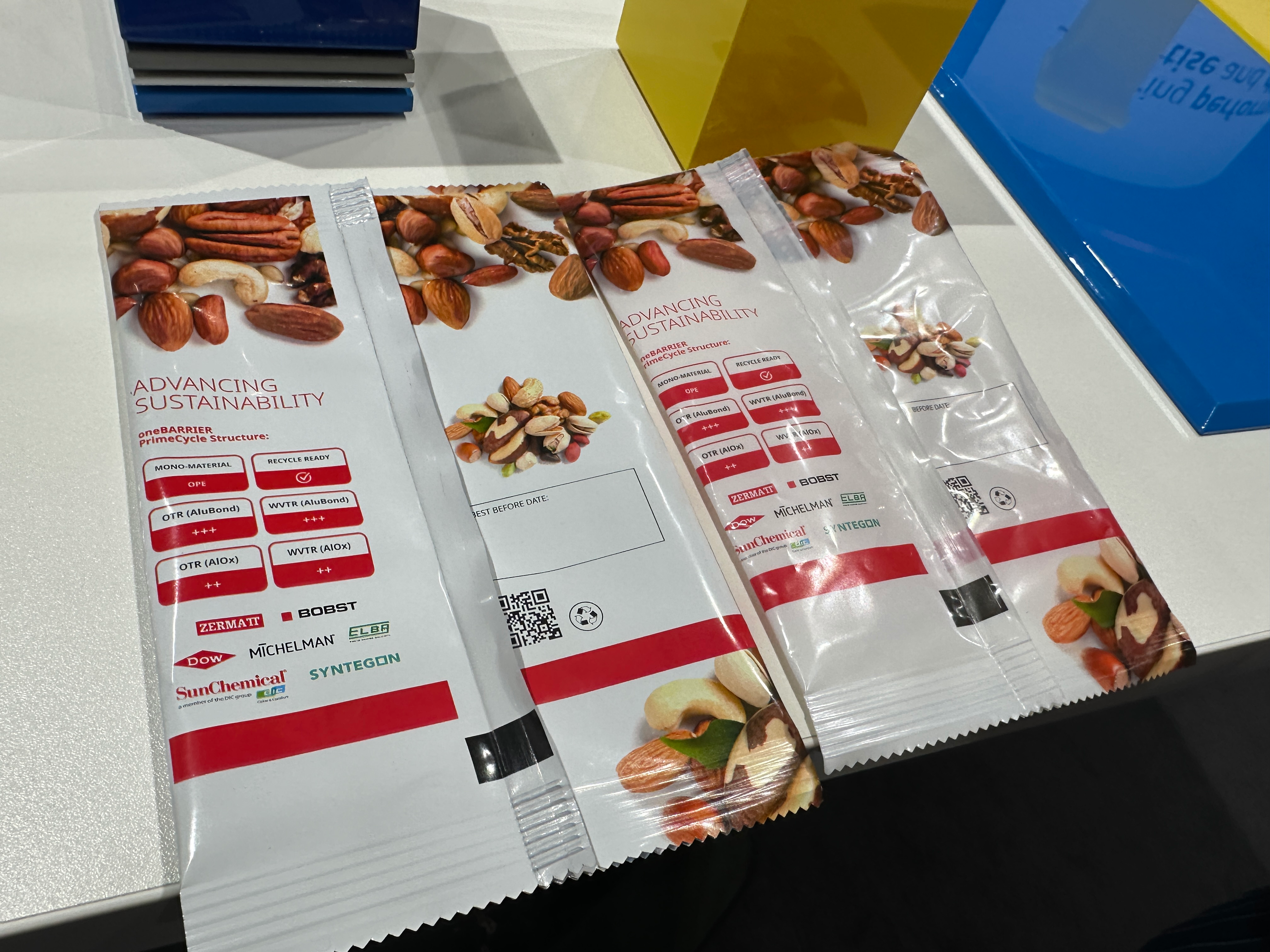 'We said at the beginning, we need to replace the aluminum layer, but we said we should also avoid over-engineering when possible. So we set ourselves two separate targets. The first one was to find a barrier level which is the equivalent of metalized PET. And we're talking barrier to water vapor (WVTR) and barrier to oxygen (OTR). The equivalent of metallized PET is a barrier of less than 1 OTR, and less than 1 WVTR. We also needed a barrier which is equivalent to aluminum. So we need to have less than 0.1, OTR and less than 0.1 WVTR. And if you look at the values here, AluBond, the metallized version, has three points. And that is the equivalent of less than 0.1 OTR and WVTR, so that's your aluminum barrier. And for those who don't need that level, you can have the option of the transparent version, which here you can see as the AlOx (aluminum oxide), we've called it and that has two pluses, because that's that less than 1 OTR, and less than 1 WVTR. In our language to simplify things we call one high barrier and the other ultra-high barrier,' Alexander says.