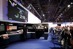 An operator readies a cartonboard demo run on a Landa S11 Nanographic digital printer at drupa this month.