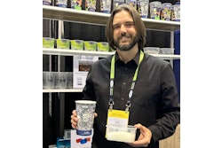 Churchill Container’s Erik Johnson holds one of the cups made from 50% recycled content from PP purification along with a container of PureFive resin.