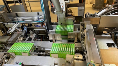 Shown here in the tray packer are one 12-count group of cartons in the flap compression station, another in the tray load station, and a third that is about to be pushed into the tray load station.