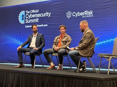 Ivan Gotti of Okta (left) and John Gall of Cloudflare (center) discuss cloud security with Darren Friedel, cybersecurity engineer at the Center for Internet Security at the Cybersecurity Summit in Chicago.