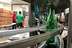 Returnable bottles of Sun Drop stay snugly on track with Multi-Conveyor’s tabletop system.
