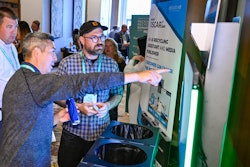 Brian Sano (left) of Oscar Sort demonstrates the system to Patrick Keenan of General Mills.