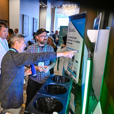 Brian Sano (left) of Oscar Sort demonstrates the system to Patrick Keenan of General Mills.