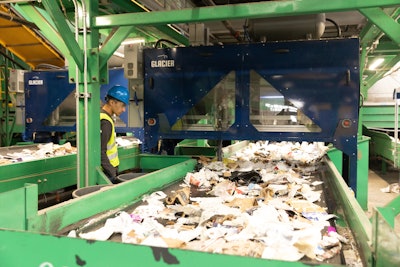 A stream of recycled waste, mostly packaging, enters Glacier's AI-supported robotic sortation equipment.