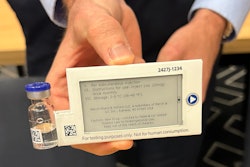 A prototype of a digital display label attached to a vial containing a drug for a clinical trial.