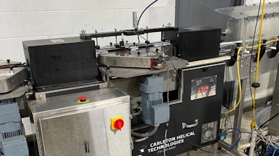 Inverter/reverter system with ionized air rinsing and inkjet date coding operations being accomplished in the short period while the cans are inverted.