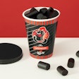 Kouvolan Lakritsi, a family-run confectionery known for its traditionally cooked licorice, has unveiled a new recyclable and reclosable paper cup for retail. Image courtesy of Metsä Group.