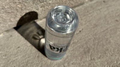 The PET 'can' employs a dimple or indentation (can be called a punt) that helps to add strength and structural integrity to the container.