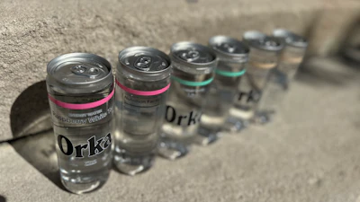 Orka energy drinks are filled in a PET bottle with aluminum closures seamed on, and what appears to be a lightly printed, otherwise transparent pressure-sensitive PE label.