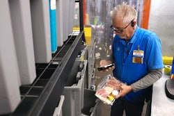Walmart associate handling fresh food.