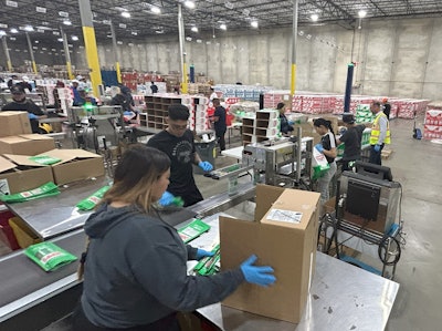 Workers re-pack work-in-progress pouches of Chomps.