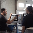 Frédéric Boyadjian, head of automation, and Cédric Gaudreault, automation designer, fine-tune the settings of Impack’s new automation app on a GenieCut.