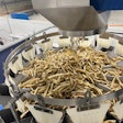 This 14-head combination scale drops 5-lb portions of Frozen French fries into a vertical form/fill/seal system below.