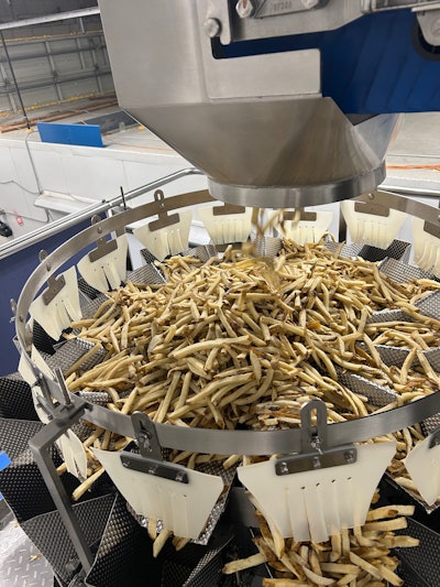 This 12-head combination scale drops 5-lb portions of Frozen French fries into a vertical form/fill/seal system below.