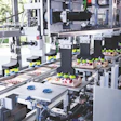 Automated industrial packaging machine with robotic arms processing food containers