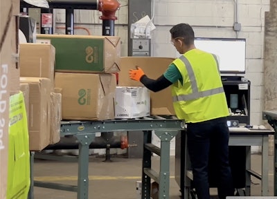 The facility receives from 500 to 1,000 parcels per day that are each weighed, scanned, and grouped into material categories before the contents of the boxes are sorted.