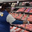 Walmart associate scans fresh meat products tagged with RFID-enabled labels.