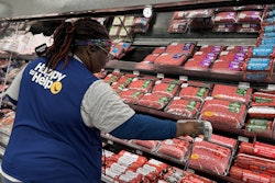 Walmart associate scans fresh meat products tagged with RFID-enabled labels.