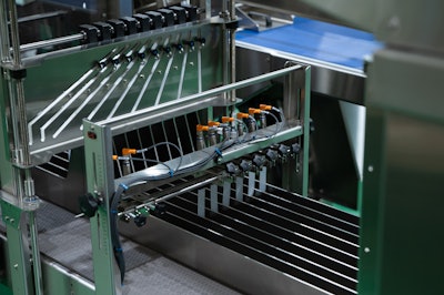 Since Specialty Blends runs three different bottle widths, these lanes feeding the tray former and packer need to be adjusted, and a patented single-point adjustment feature makes it possible to do this by simply turning an adjustment wheel.