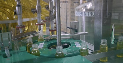 Filled bottles exit the 24-head rotary filler by way of this discharge starwheel.