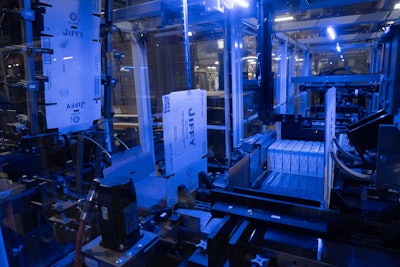 Corrugated case blanks are picked from a magazine feed and placed in a station so that 24 collated cartons can be pushed into the wraparound case.