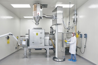 Drums containing each ingredient are lifted, aligned with the mixer's stationary inlet, and emptied&mdash;in a prescribed order according to the Master Batch Record.