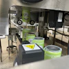 Shrink sleeves being 'shot' onto awaiting bright cans, pictured here traveling into the steam tunnel.