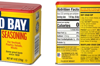 Old Bay Seasoning in tin: McCormick’s Old Bay returns to its classic printed tin canister—iconic blue-and-yellow graphics with a red lid—shown here with front panel and back label (nutrition facts/recipes).
