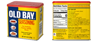 Old Bay Seasoning in tin: McCormick’s Old Bay returns to its classic printed tin canister—iconic blue-and-yellow graphics with a red lid—shown here with front panel and back label (nutrition facts/recipes).