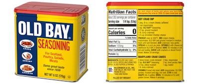 Old Bay Seasoning in tin: McCormick’s Old Bay returns to its classic printed tin canister—iconic blue-and-yellow graphics with a red lid—shown here with front panel and back label (nutrition facts/recipes).