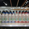 Rows of Collective Good bottled products in various colors on store shelf