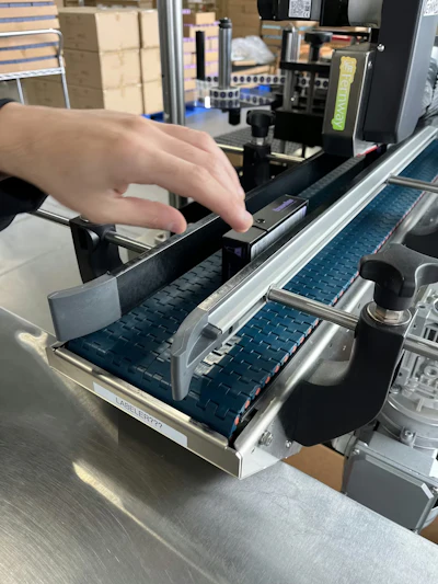 Fernway’s Paxiom dual-head labeler applies regulatory and branding labels to opposite sides of premium cartons at up to 40 per minute.