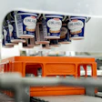 Finlandia dairy product containers on orange crate in food processing facility