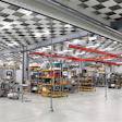 Modern manufacturing facility with automated packaging machines and yellow equipment
