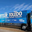 Blue Mettler Toledo commercial truck parked on roadside with open door