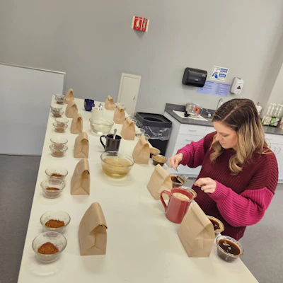 Napco Brands has been roasting and producing coffee since the early 1900s and has four in-house brands. Ali Papanicholas, Quality Assurance and Green Coffee Buyer at Napco Brands, tests multiple coffee samples.