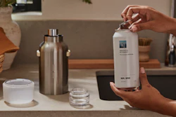 The aluminum refill can is opened and inserted into the reusable stainless steel vessel, where it locks into place for dispensing.