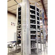 Industrial multi-level conveyor system with white frame and black belt mechanisms in warehouse facility