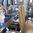One group of 24 bottles has just been swept onto a corrugated case while the next group is collated and ready to be swept onto the next case.
