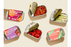 Row 7’s tinned vegetables are packed in small-format tins with paperboard sleeves that leave the container visible, reinforcing the brand’s produce-aisle positioning and connection to fresh, flavor-bred vegetables.