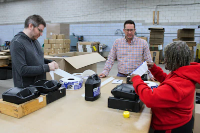 Business Development Specialist Keith Coffindaffer checks in on a labeling operation.
